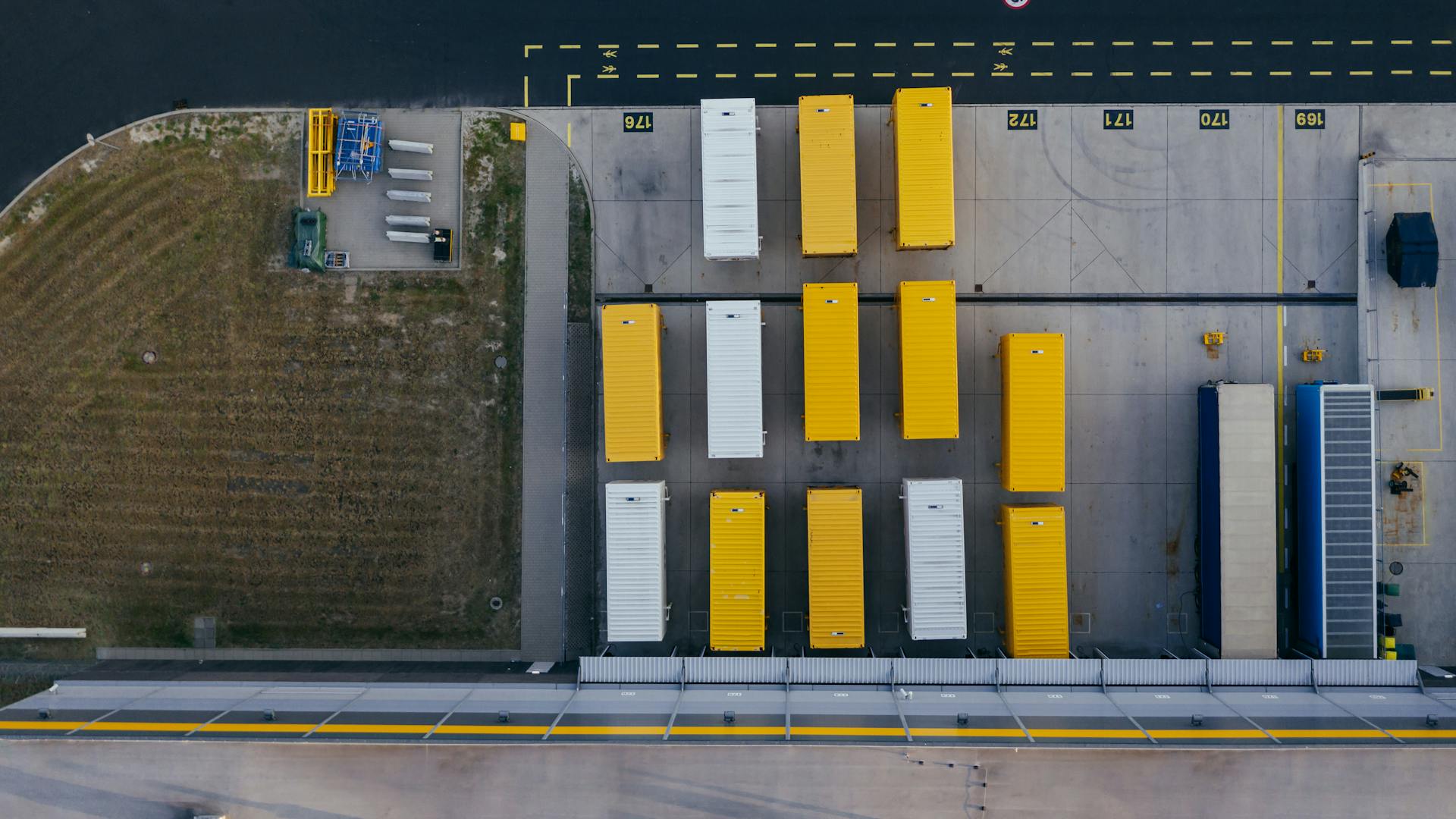 Aerial shot of colorful cargo containers at a warehouse in Poznań, Poland.