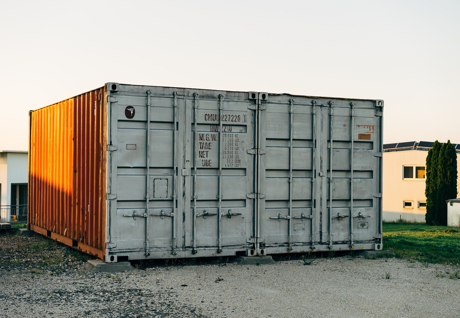 Outdoor view of a metal shipping container at a storage facility.